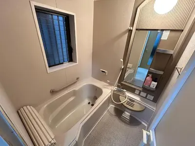 a bathroom with a tub and a sink and a mirror at Tokyo log house with Free parking in Tokyo