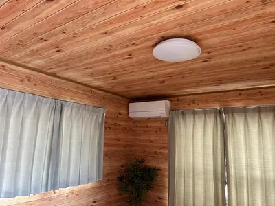 a room with a wooden ceiling with a light and a window at Tokyo log house with Free parking in Tokyo