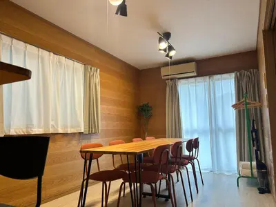 a dining room with a table and chairs at Tokyo log house with Free parking in Tokyo