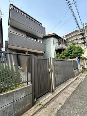 a fence in front of a house at Tokyo log house with Free parking in Tokyo