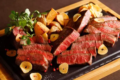 a plate of meat and other food on a table at Hotel New Otani Tokyo Garden Tower in Tokyo