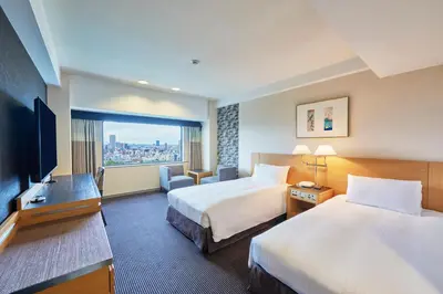 a hotel room with two beds and a flat screen tv at Hotel New Otani Tokyo Garden Tower in Tokyo