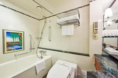 a bathroom with a toilet and a sink and a tub at Hotel New Otani Tokyo Garden Tower in Tokyo