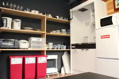 a kitchen with red and white appliances and shelves at RY-Whole \u6d45\u8349\u3067\u5bb6\u65cf\u65c5 2\u5bdd\u5ba42\u6d74\u5ba4\u306e\u4e00\u68df\u8cb8\u5207 \u65e5\u672c\u4ebaSuperHost in Tokyo