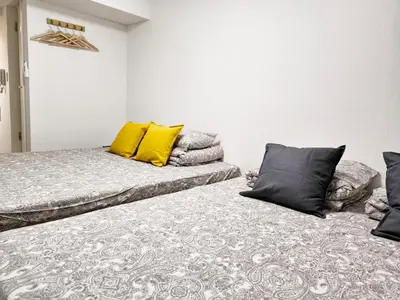 two beds sitting next to each other in a room at T Stay in Tokyo