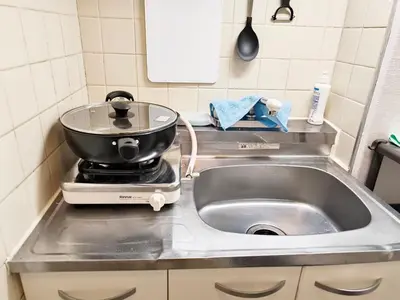 a kitchen sink with a pot on top of it at T Stay in Tokyo