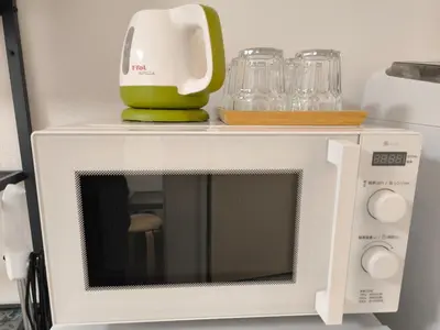 a white microwave with a blender on top of it at T Stay in Tokyo