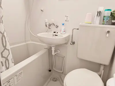 a small bathroom with a sink and a toilet at T Stay in Tokyo