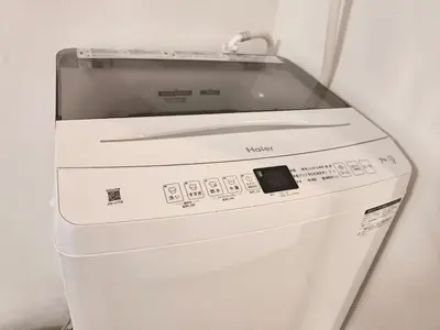 a white washing machine with a glass top at T Stay in Tokyo
