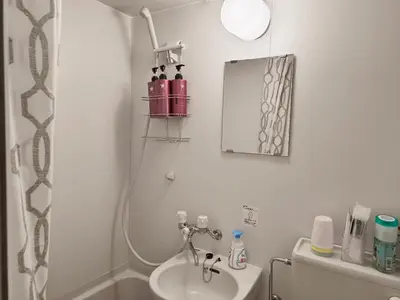 a bathroom with a sink and a mirror at T Stay in Tokyo