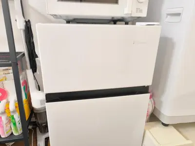 a white refrigerator with a microwave on top of it at T Stay in Tokyo
