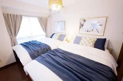 a bedroom with two beds and a window at NH building5F in Tokyo