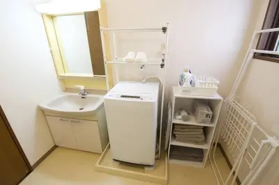 a small bathroom with a sink and a washing machine at NH building5F in Tokyo