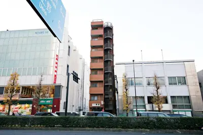 a city street with cars parked in front of buildings at NH building5F in Tokyo