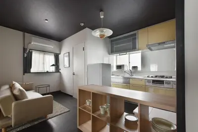 a kitchen with a table and a couch in a room at \u5ca1\u7530\u30d3\u30eb5\u968e in Tokyo