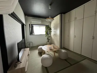 a room with a table and some white cabinets at \u5ca1\u7530\u30d3\u30eb5\u968e in Tokyo