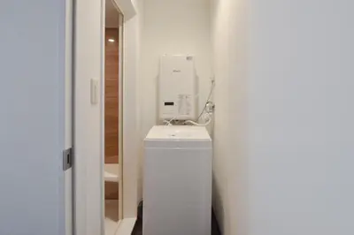 a bathroom with a white dryer sitting on top of a toilet at \u5ca1\u7530\u30d3\u30eb5\u968e in Tokyo