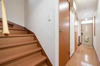 a hallway with stairs and a toilet in a building at \u30a2\u30f3\u30c9\u30b9\u30c6\u30a4\u5fd7\u83025\u4e01\u76ee in Tokyo