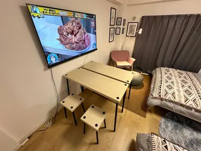 a room with a table and a tv on the wall at \u65b0\u5bbf\u795e\u697d\u5742\u8fd1\u304f\u5bff\u53f8\u5e972 in Tokyo