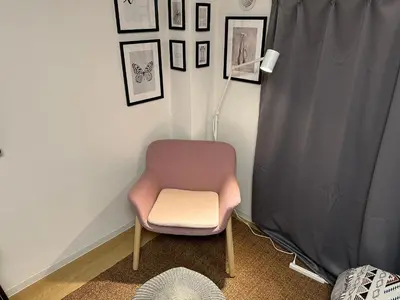 a chair in a room with pictures on the wall at \u65b0\u5bbf\u795e\u697d\u5742\u8fd1\u304f\u5bff\u53f8\u5e972 in Tokyo