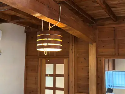 a light fixture hanging from a ceiling in a room at \u795e\u697d\u5742\u6238\u5efa\u3066\u30b5\u30a6\u30b9 in Tokyo