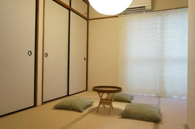 a room with a table and two pillows at ALDO INN Kitasenju 3F in Tokyo