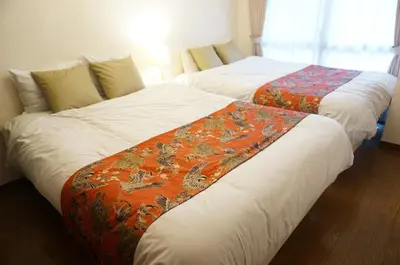 two beds sitting next to each other in a room at ALDO INN Kitasenju 3F in Tokyo