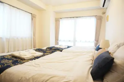 a large bed in a room with a window at ALDO INN Kitasenju 3F in Tokyo