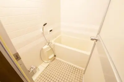 a small white bathroom with a toilet and a tub at ALDO INN Kitasenju 3F in Tokyo