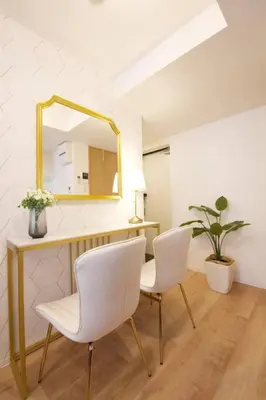 a room with two white chairs and a mirror at Musashi's hotel IKEBUKURO2F in Tokyo