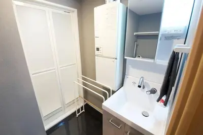 a small bathroom with a sink and a mirror at \u30b6\u30fb\u30b8\u30a7\u30df\u30cb\u30b9\u6c60\u888b101 in Tokyo