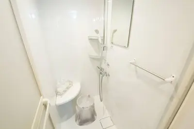 a white bathroom with a shower and a sink at \u30b6\u30fb\u30b8\u30a7\u30df\u30cb\u30b9\u6c60\u888b101 in Tokyo