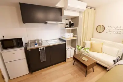 a small apartment with a kitchen and a living room at \u30b6\u30fb\u30b8\u30a7\u30df\u30cb\u30b9\u6c60\u888b101 in Tokyo