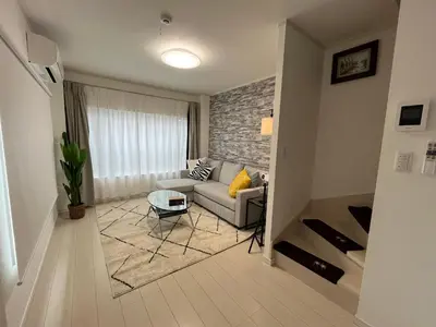 a living room with a couch and a table at Relax House in Tokyo