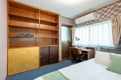 a hotel room with a bed and a desk at Sharil Nishi-Shinjuku in Tokyo