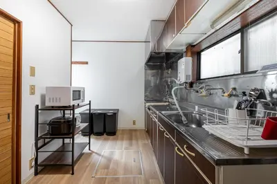 a kitchen with a sink and a microwave at Sharil Nishi-Shinjuku in Tokyo