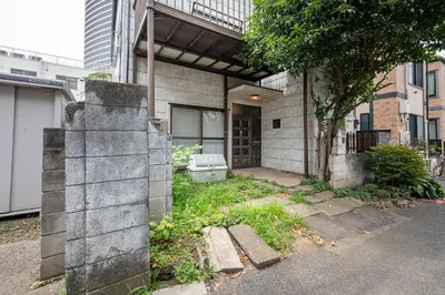 a house with a cement block wall in front of it at Sharil Nishi-Shinjuku in Tokyo