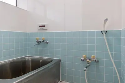 a bathroom with a bath tub with a hose at Sharil Nishi-Shinjuku in Tokyo