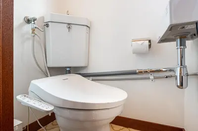 a bathroom with a toilet with a remote control at Sharil Nishi-Shinjuku in Tokyo