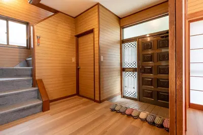 a hallway with wood paneling and a door at Sharil Nishi-Shinjuku in Tokyo