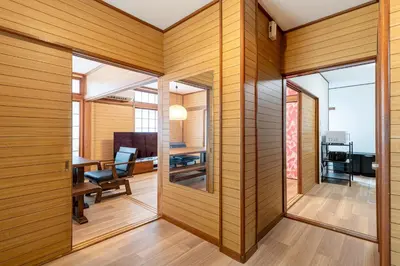 an office with wood paneling and a room with a table and chairs at Sharil Nishi-Shinjuku in Tokyo