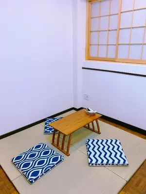 a room with two mats and a table and a window at miki II in Tokyo