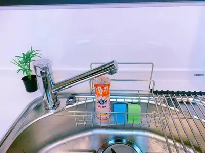 a sink with a dish rack with cleaning products in it at miki II in Tokyo