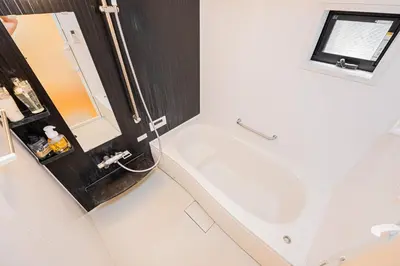 a bathroom with a white tub and a sink at Ikebukuro Shopping Street 3BR in Tokyo