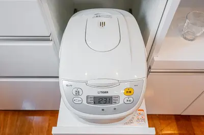 a white hair dryer sitting on a shelf at Ikebukuro Shopping Street 3BR in Tokyo