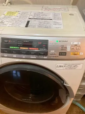 a washing machine with a box on top of it at Guesthouse cherry in Tokyo