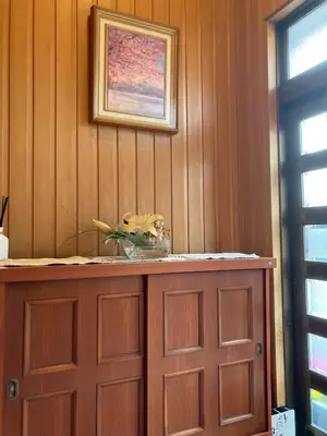 a wooden cabinet with a vase on top of it at Guesthouse cherry in Tokyo