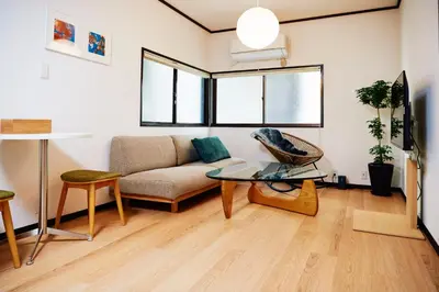 a living room with a couch and a glass table at 1stop to Shibuya station Japanese traditional house in Tokyo