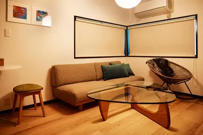a living room with a couch and a glass table at 1stop to Shibuya station Japanese traditional house in Tokyo