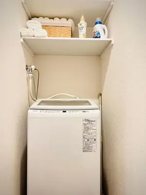 a small refrigerator in a corner with a shelf at \u685cHome in Tokyo